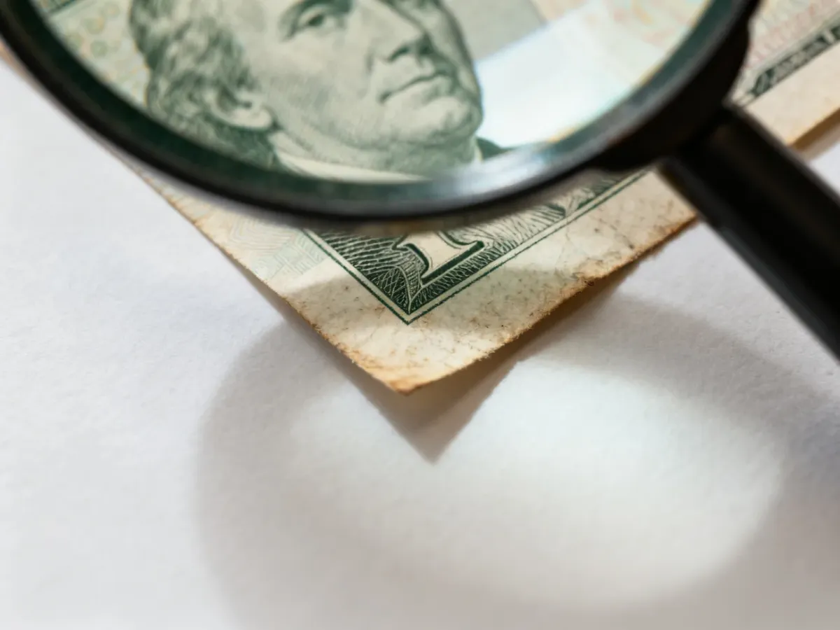 Zbliżenie rogu banknotu oglądanego przez lupę
